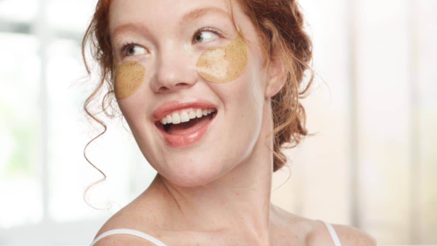 woman wearing eye gels to smooth and boost glow for fall weather transition from summer sun to cooler weather