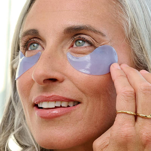 woman wearing on ice eye patches under eyes close up