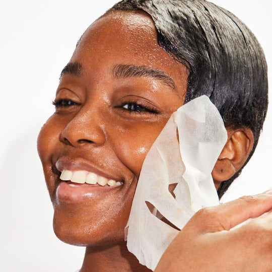 woman wearing mood mask sheet mask glowing skin