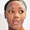 woman wearing sheet mask hydrating mask